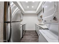 Updated kitchen with stainless steel appliances and white cabinets at 18202 N Cave Creek Rd # 115, Phoenix, AZ 85032