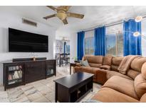 Relaxing living room with a sectional sofa and large TV at 1825 W Ray Rd # 1001, Chandler, AZ 85224