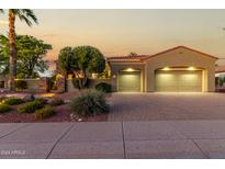 Two-story house with a two-car garage and desert landscaping at 13232 W Los Bancos Dr, Sun City West, AZ 85375