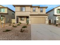 Two-story house with a beige exterior, two-car garage, and landscaping at 31751 N Velvet Rush Rd, San Tan Valley, AZ 85143