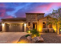 Single-story home with stone accents and desert landscaping at 28694 N 127Th Ln, Peoria, AZ 85383
