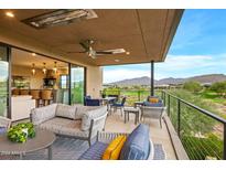 Covered patio with comfortable seating, mountain views, and golf course views at 37200 N Cave Creek Rd # 1082, Scottsdale, AZ 85262