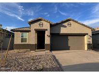New single story home with two car garage and desert landscaping at 38100 W Excussare Way, Maricopa, AZ 85138