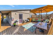 Relaxing patio with seating area, umbrella, and wood deck at 3233 N 37Th St # 9, Phoenix, AZ 85018