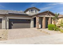 Modern home with solar panels and brick facade at 24884 N 171St Ln, Surprise, AZ 85387