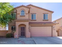 Two-story home with a large garage and front yard at 7309 W Carter Rd, Laveen, AZ 85339