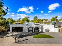 Modern home exterior with landscaped lawn and driveway at 408 E Claremont St, Phoenix, AZ 85012