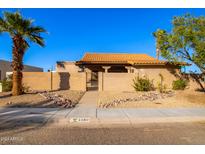 Tan stucco home with tile roof and gated entry at 5160 E Karen Dr, Scottsdale, AZ 85254