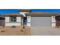 Newly constructed home with gray garage door and desert landscaping at 7400 E White Tail Rd, San Tan Valley, AZ 85143