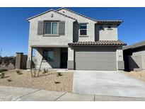 Two-story house with gray siding, gray garage door, and small front yard at 8512 N 170Th Ln, Waddell, AZ 85355