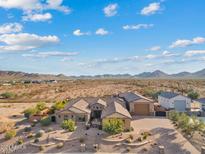 Aerial view of a single-story house with desert landscape at 10803 W Dove Roost Rd, Queen Creek, AZ 85144