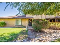 Front view of two-story townhome with landscaping and walkway at 1720 W Village Way, Tempe, AZ 85282