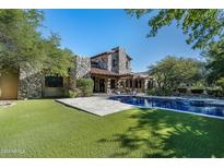 Inviting backyard pool with expansive lawn and patio at 20242 N 103Rd Way # 1246, Scottsdale, AZ 85255
