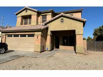 Two story home with large front yard and attached garage at 9406 W Elwood St, Tolleson, AZ 85353