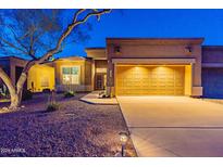 Night view of a single-story home with a two-car garage at 7082 E Palo Brea Dr, Gold Canyon, AZ 85118