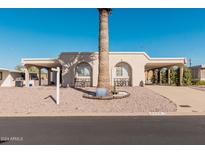 House exterior with arched entryways and a palm tree at 8228 E Calypso Ave, Mesa, AZ 85208