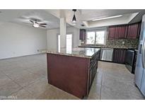 Kitchen with granite island and dark wood cabinetry at 8214 E Mcdonald Dr, Scottsdale, AZ 85250