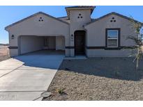 New construction home with a two-car garage and desert landscaping at 18765 E Bruno Dr, Gold Canyon, AZ 85118