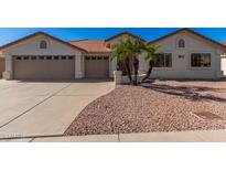 Single-story home with tan exterior and palm trees at 2222 S Yellow Wood --, Mesa, AZ 85209