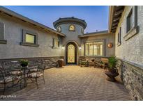 Elegant courtyard entry with sitting area and ornate door at 4126 S Last Chance Trl, Gold Canyon, AZ 85118
