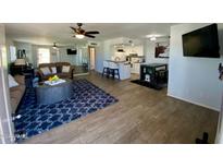 Open concept living room and kitchen with modern flooring at 14416 N Teakwood Ln # D, Fountain Hills, AZ 85268