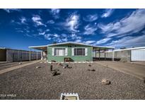 Mobile home with a well-maintained front yard and gravel landscaping at 260 S 72Nd Pl, Mesa, AZ 85208