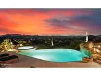 Stunning infinity pool with a waterfall and city views at 11155 E Honda Bow Rd, Scottsdale, AZ 85262