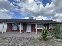 Brick ranch house with covered porch and landscaping at 4232 W Citrus Way, Phoenix, AZ 85019