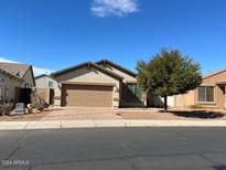 One-story home with a two-car garage and front yard at 3030 S 102Nd Ln, Tolleson, AZ 85353