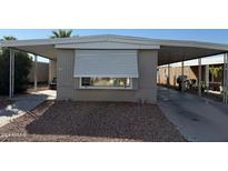 Mobile home exterior with carport and gravel driveway at 6839 W Villa St # 113, Phoenix, AZ 85043