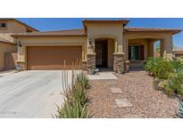 Tan house with brown garage door and stone accents at 5526 S Grenoble St, Mesa, AZ 85212