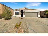 Single story home with a two-car garage and desert landscaping at 5850 E Everhart Ln, Florence, AZ 85132