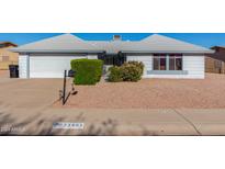 House exterior with a two-car garage and landscaping at 11451 S Pawnee Cir, Phoenix, AZ 85044