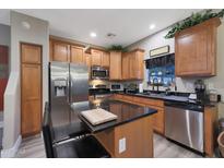 Modern kitchen with stainless steel appliances and wood cabinets at 2725 E Mine Creek Rd # 1079, Phoenix, AZ 85024