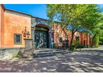 Spanish-style home with large wooden doors and lush landscaping at 8100 N 68Th St, Paradise Valley, AZ 85253
