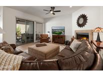 Relaxing living room with fireplace and patio access at 27504 N Montana Dr, Rio Verde, AZ 85263