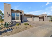 Modern stucco home with 2-car garage and desert landscaping at 35300 N Sunset Trl, Queen Creek, AZ 85140