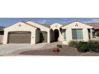 Single-story home with a two-car garage and desert landscaping at 2360 N 165Th Dr, Goodyear, AZ 85395