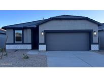 Modern single story home with gray exterior and two-car garage at 38155 W Excussare Way, Maricopa, AZ 85138