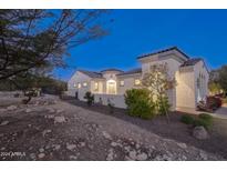Stunning desert home exterior at dusk at 20594 W Pasadena Ave, Buckeye, AZ 85396