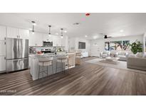 Modern kitchen with island, stainless steel appliances, and granite countertops at 1173 E Cordova Ave, Casa Grande, AZ 85122