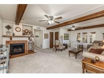 Spacious living room with fireplace and exposed beams at 455 S Delaware Dr # 1, Apache Junction, AZ 85120