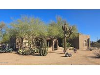 Desert landscape surrounds this charming one-story home with stucco exterior and arched window at 2926 W Tanya Trl, Phoenix, AZ 85086