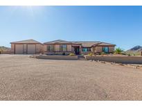 Single-story home with a 3-car garage and desert landscaping at 32853 N Bell Rd, Queen Creek, AZ 85144