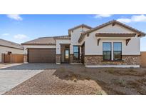 Single-story home with stone accents and a two-car garage at 683 E Grayling Rd, San Tan Valley, AZ 85140