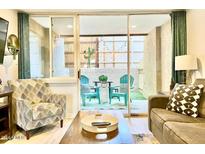 Bright living room with access to a private patio at 7625 E Camelback Rd # B108, Scottsdale, AZ 85251