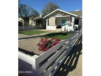 Neatly landscaped front yard with artificial turf and a white picket fence at 1122 E Portland St # A, Phoenix, AZ 85006