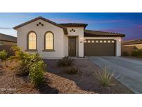 Charming one-story home with a brown garage door and desert landscaping at 453 E Wiley Way, Casa Grande, AZ 85122
