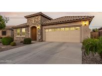 Two-story house with stone facade and three car garage at 6181 S Granite Dr, Chandler, AZ 85249