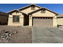 One-story house with brown garage door at 11560 W Kinderman Dr, Avondale, AZ 85323